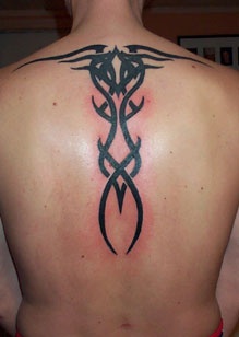 Black ink tribal tattoo on back