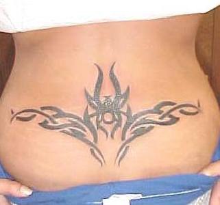 Big lower back tattoo in tribal style