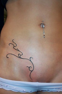 Lower belly tribal tattoo with thin twisted lines