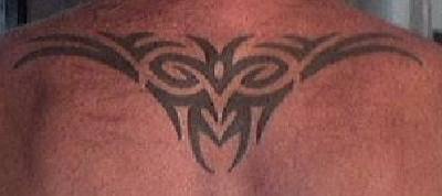 Upper back tattoo of tribal sign