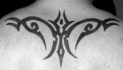 Simple tribal tattoo on upper back