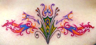Colorful tribal tattoo on lower back