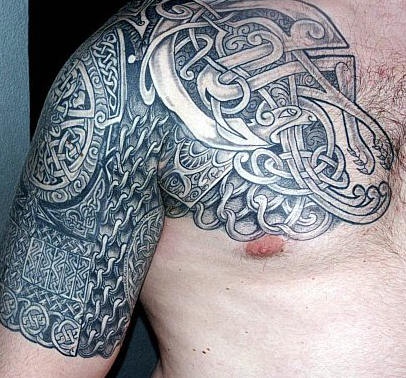 Big tribal tattoo on shoulder and chest