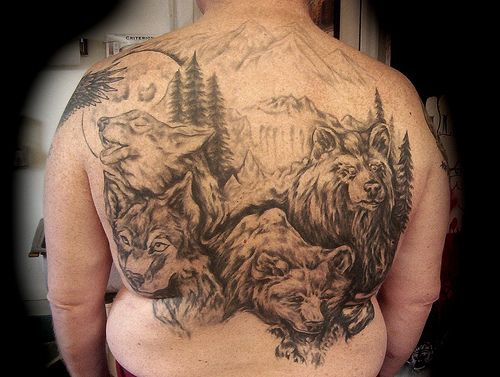 Tattoo with pack of wolves on whole back