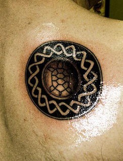 Tattoo of circle tribal sign with turtle in the middle