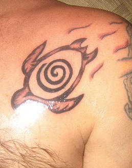 Chest tattoo of turtle with swirl on shell