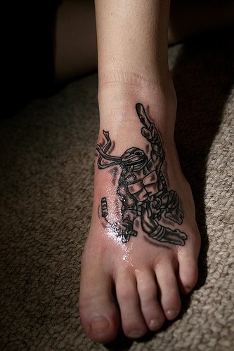 Foot tattoo of teenage mutant ninja turtle