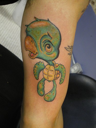 Funny small turtle with big head tattoo
