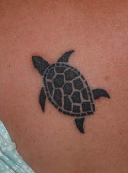Very small black turtle tattoo