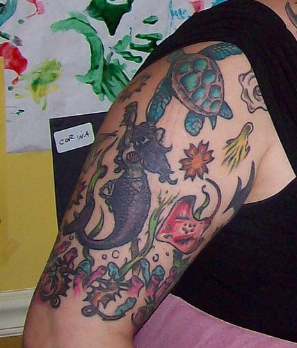 Marine mermaid and tortoise upper arm tattoo