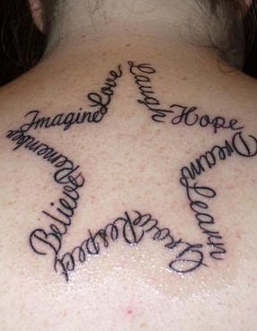 Composed tattoo on upper back star of words