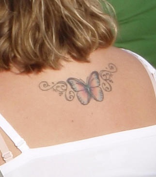 Butterfly tattoo little decorated on upper back
