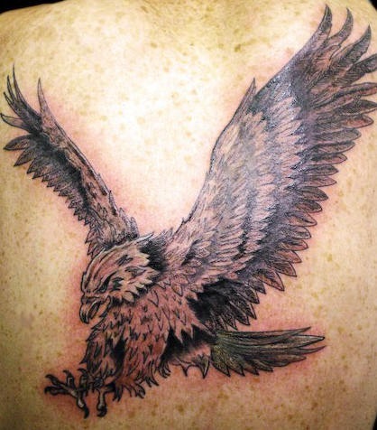On upper back aggressive flying eagle tattoo