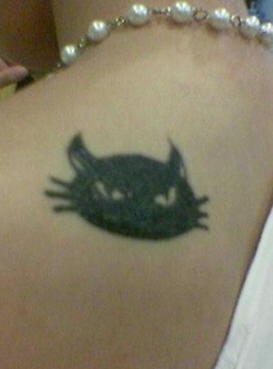 Puss on upper back sly cat&quots tattoo