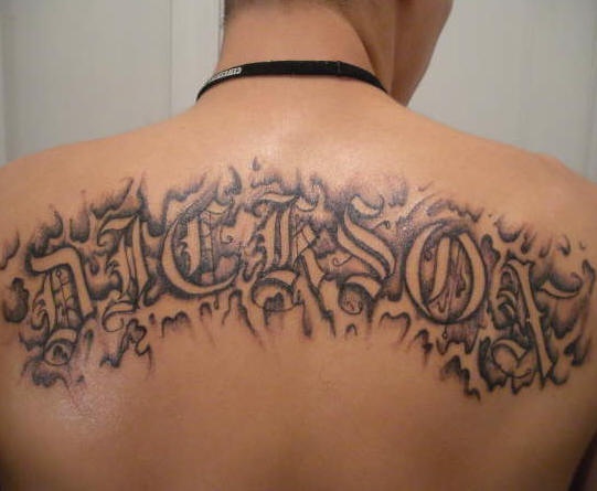Nickson tattoo black disguised inscription on upper back
