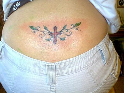Cross with tracery tattoo on tail base