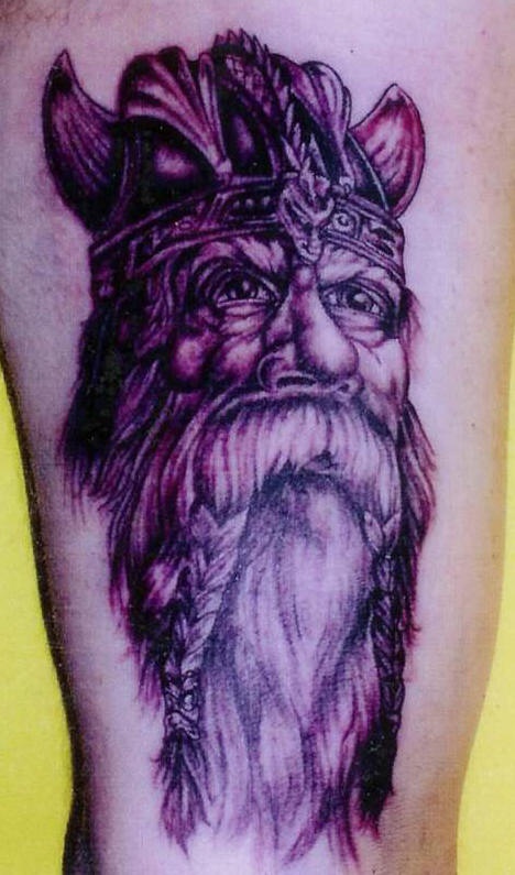 Viking tattoo of old warrior with braids on mustache