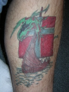 Viking tattoo of colorful ship with green dragon