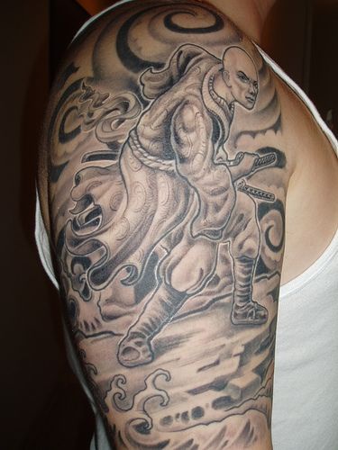Big warrior hand tattoo in black ink