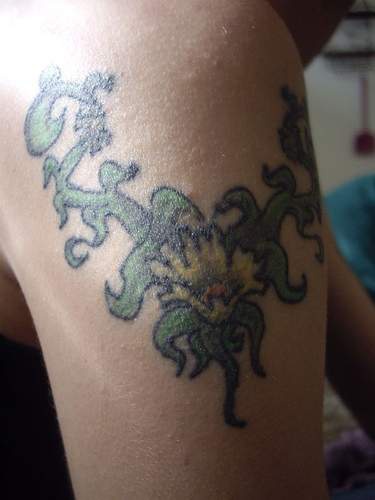 Colored shoulder tattoo of vine with flower