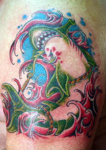 Tattoo with green shark in rope