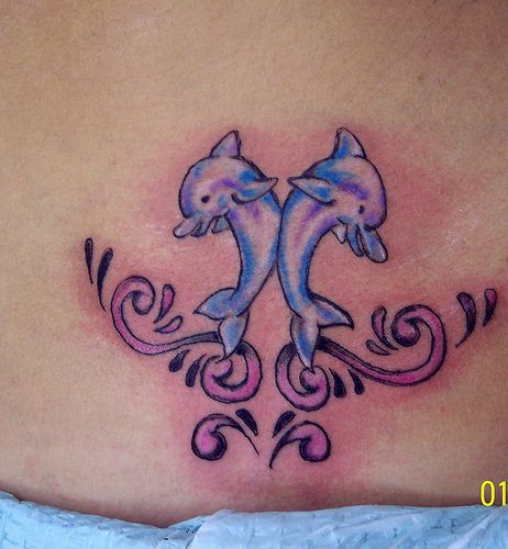 Water animal tattoo with two happy dolphins