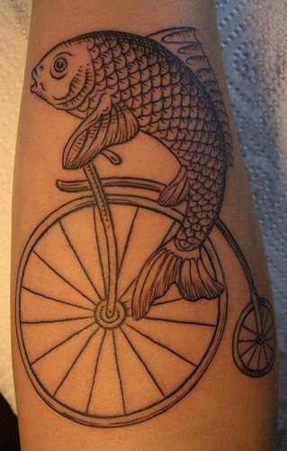 Tattoo with fish on the old bicycle