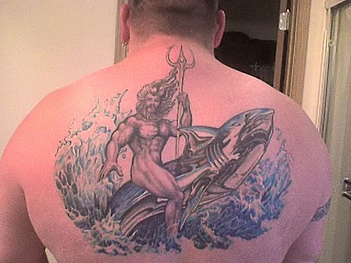 Man with trident on the whale in waves back tattoo