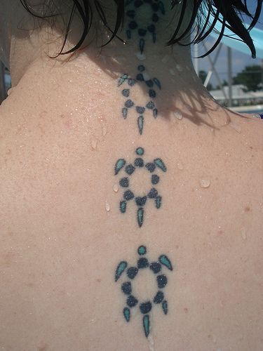 Water animal tattoo with small turtles on back neck