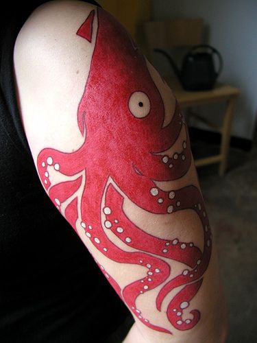Big red octopus tattoo on hand