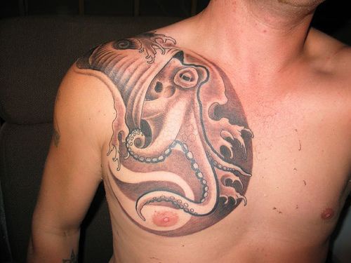 Big octopus tattoo on chest in brown colors