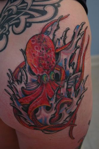 Tattoo with red octopus in waves