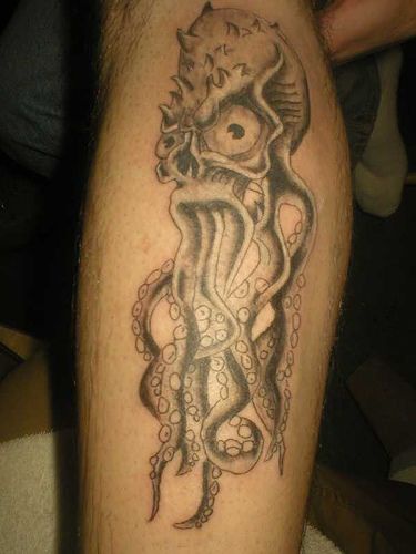 Scary octopus with big eyes tattoo on leg