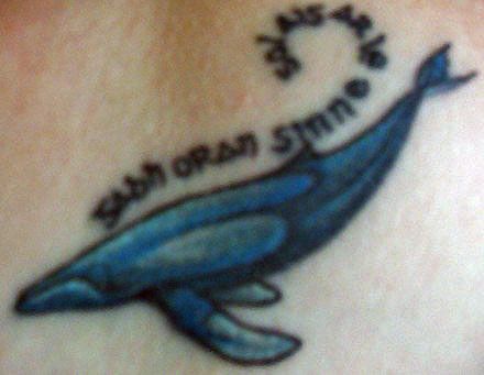 Water animal tattoo with whale and inscription