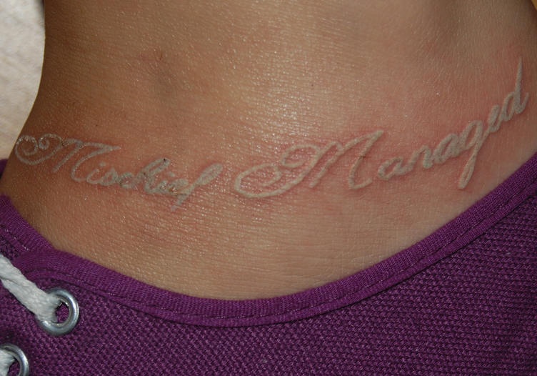White ink ankle tattoo with inscription