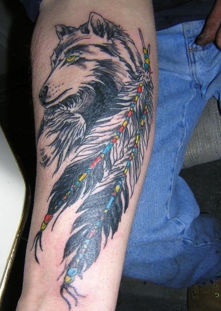 Tattoo with wise wolf and two big feathers