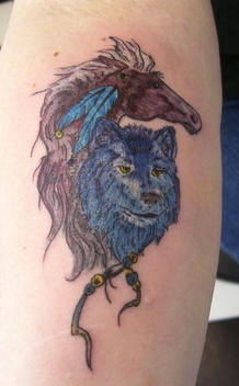 Blue wolf with brown horse tattoo