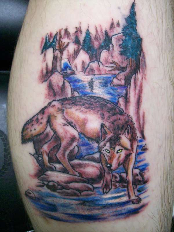 Colored tattoo with wolf near a rivulet