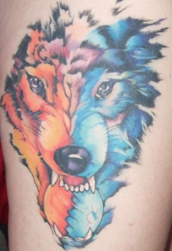 Orange and blue wolf head tattoo