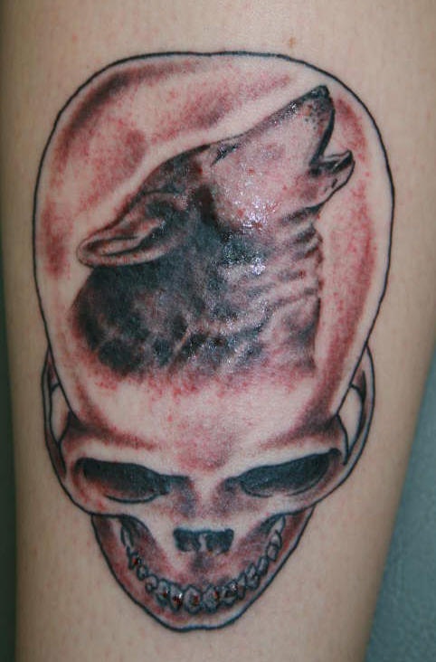 Tattoo with human skull and wolf