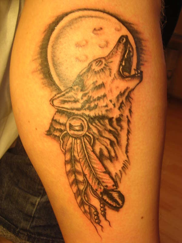 Wolf Tattoo mit einem Mond und Federn