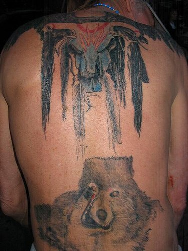 Tattoo with wolves play on back