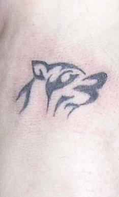 Small wolf tattoo in tribal style