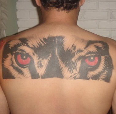 Tattoo with wolves eyes on back