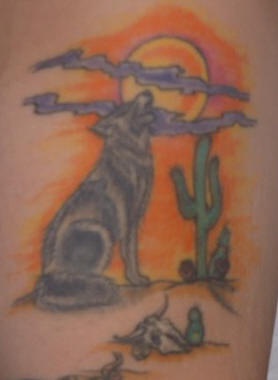 Tattoo with wolf in a desert