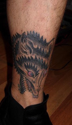 Funny wolf tattoo on the leg