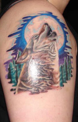 Wolf is howling at the moon tattoo