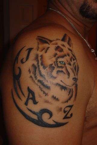 Brown wolf tattoo with inscription jaz
