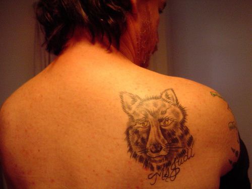 Wolf head tattoo on scapula