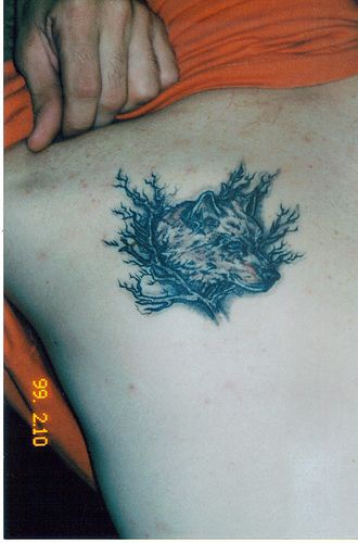 Wolf tattoo with shrubs